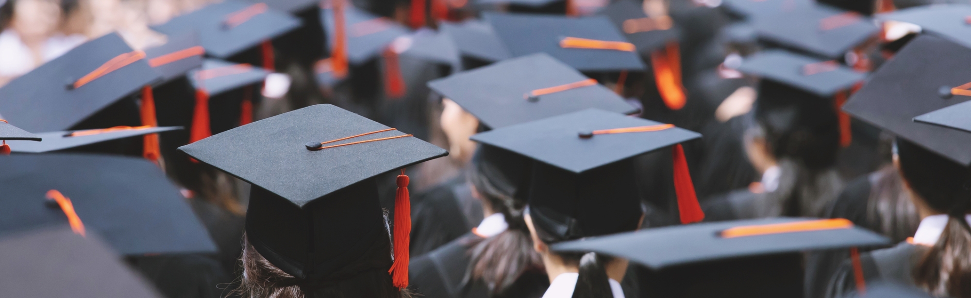 Students graduating, in their caps and gowns