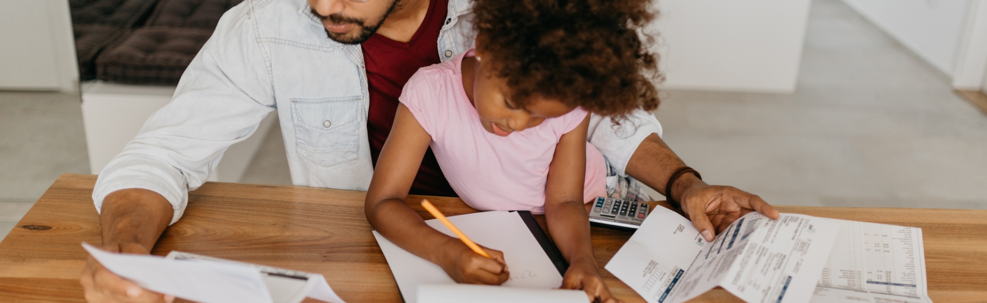 Dad struggling with debt, sitting with young daughter